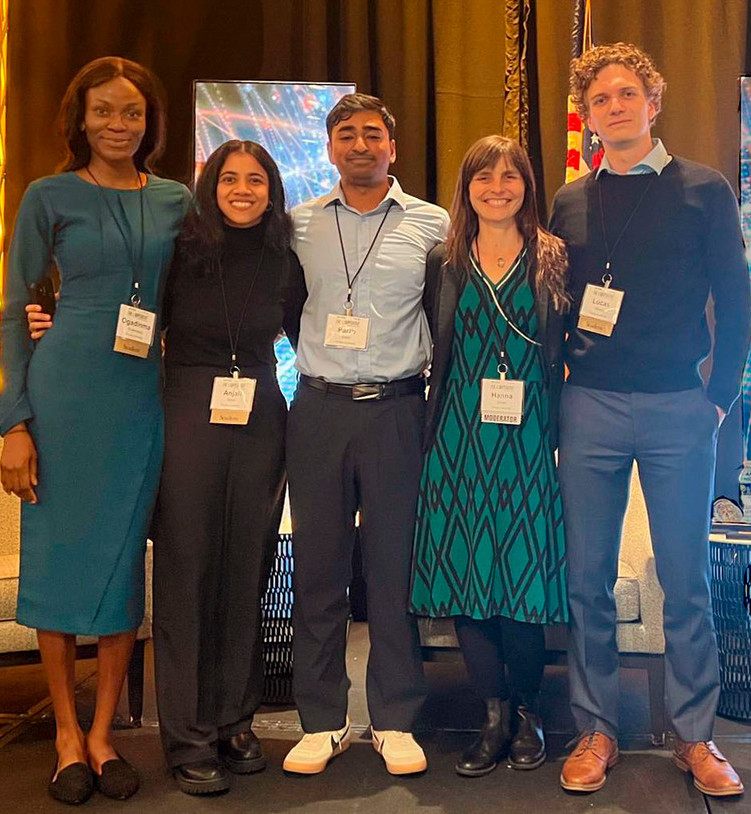 Five GRAIL researchers wearing conference badges, standing together at a conference.